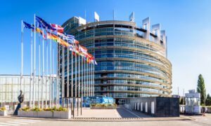 Entrance of the Louise Weiss building, seat of the European Parliament, and flags of the member states of the European Union in Strasbourg, France.